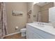 Bright bathroom featuring a white vanity, neutral walls with coastal artwork, and tile flooring at 2669 Wax Myrtle Ct, Port Charlotte, FL 33953
