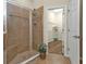 Modern bathroom featuring tiled shower with glass doors and a walk in closet at 2669 Wax Myrtle Ct, Port Charlotte, FL 33953