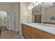 Bright bathroom featuring double sinks, a large mirror, and a separate shower and tub at 2669 Wax Myrtle Ct, Port Charlotte, FL 33953
