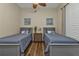 Shared bedroom with two twin beds, a central nightstand, neutral walls, and cozy linens at 2669 Wax Myrtle Ct, Port Charlotte, FL 33953