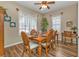 Traditional dining room with hardwood floors, ceiling fan, and natural light at 2669 Wax Myrtle Ct, Port Charlotte, FL 33953