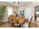 Charming dining room featuring hardwood floors, a ceiling fan, and neutral walls at 2669 Wax Myrtle Ct, Port Charlotte, FL 33953