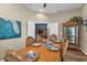 Dining room with hardwood floors, blue accent painting, and an entertainment cabinet at 2669 Wax Myrtle Ct, Port Charlotte, FL 33953