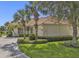 Charming single-story home featuring a tile roof, lush landscaping, and a well-manicured lawn at 2669 Wax Myrtle Ct, Port Charlotte, FL 33953