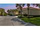 Scenic home exterior at twilight, surrounded by palm trees, mature landscaping, and a private driveway at 2669 Wax Myrtle Ct, Port Charlotte, FL 33953