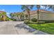 Well-maintained exterior with a concrete driveway leading to the two-car garage and lush, trimmed landscaping at 2669 Wax Myrtle Ct, Port Charlotte, FL 33953