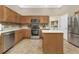Bright kitchen featuring wooden cabinets, stainless steel appliances, and a center island for ample workspace at 2669 Wax Myrtle Ct, Port Charlotte, FL 33953