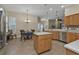 Open-concept kitchen featuring stainless steel appliances, a center island, and adjacent dining area at 2669 Wax Myrtle Ct, Port Charlotte, FL 33953