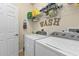Convenient laundry room with modern appliances and ample storage space at 2669 Wax Myrtle Ct, Port Charlotte, FL 33953