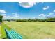 Lawn area featuring lush lawn, shady benches and mature landscaping at 2669 Wax Myrtle Ct, Port Charlotte, FL 33953