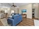 Inviting living room with hardwood floors, ceiling fan, and view into dining area at 2669 Wax Myrtle Ct, Port Charlotte, FL 33953
