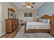 Cozy main bedroom with wooden furniture, soft lighting, and a serene blue accent wall at 2669 Wax Myrtle Ct, Port Charlotte, FL 33953