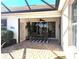 Relaxing covered patio with brick flooring and outdoor seating at 2669 Wax Myrtle Ct, Port Charlotte, FL 33953