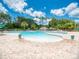 Large resort style pool with beach entry and tropical landscaping at 2669 Wax Myrtle Ct, Port Charlotte, FL 33953