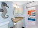 Powder room with granite-topped vanity and seahorse decoration at 2769 N Beach Rd # 105, Englewood, FL 34223
