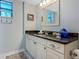 Updated bathroom features granite counters, framed mirror, and decorative accents at 2769 N Beach Rd # 105, Englewood, FL 34223