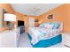 Bedroom with a comfortable bed and bright orange walls at 2769 N Beach Rd # 105, Englewood, FL 34223