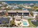 Exterior showcasing the building with a community pool and boat docks for waterfront living at 2769 N Beach Rd # 105, Englewood, FL 34223