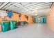 Spacious garage featuring painted walls, epoxy flooring, and ample storage for beach gear and recreational equipment at 2769 N Beach Rd # 105, Englewood, FL 34223