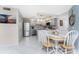 This charming eat-in kitchen features stainless appliances, granite countertops, and pendant lighting at 2769 N Beach Rd # 105, Englewood, FL 34223
