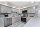 This newly remodeled kitchen features stainless steel appliances, granite countertops, and a decorative backsplash at 2769 N Beach Rd # 105, Englewood, FL 34223