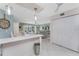 The bright, open living room is connected to the kitchen and has tile floors and access to the screened lanai at 2769 N Beach Rd # 105, Englewood, FL 34223