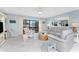 Bright and airy living room showcasing the sliding door access to the balcony at 2769 N Beach Rd # 105, Englewood, FL 34223