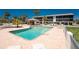 Community pool surrounded by palm trees, lounge chairs, and a nearby outdoor cabana for shaded relaxation at 2769 N Beach Rd # 105, Englewood, FL 34223