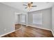 Bedroom featuring wood flooring, a ceiling fan and a window for natural light at 2821 Embassy Rd, North Port, FL 34291