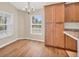 Bright dining nook with wood floors, a modern chandelier, and a large window at 2821 Embassy Rd, North Port, FL 34291