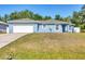 Charming single-story home with a well-maintained lawn and a two-car garage at 2821 Embassy Rd, North Port, FL 34291