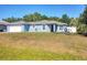 Charming single-story home with a well-maintained lawn and a two-car garage at 2821 Embassy Rd, North Port, FL 34291