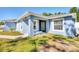 Inviting home exterior with a cozy front bench and neat landscaping details at 2821 Embassy Rd, North Port, FL 34291