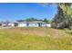 Charming single-story home with a two-car garage and manicured front lawn at 2821 Embassy Rd, North Port, FL 34291