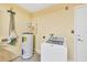 Laundry room with white washing machine and water heater at 2821 Embassy Rd, North Port, FL 34291