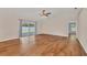 Spacious living room featuring wood flooring, a ceiling fan, and natural light at 2821 Embassy Rd, North Port, FL 34291