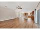 Bright, open-concept living area with wood floors connecting to a modern kitchen at 2821 Embassy Rd, North Port, FL 34291