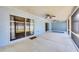 Spacious screened-in patio featuring ceiling fans, concrete flooring, and sliding glass doors overlooking the backyard at 2821 Embassy Rd, North Port, FL 34291