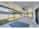 Large screened-in patio with ceiling fans and view of fenced-in backyard with green grass and privacy fence at 2821 Embassy Rd, North Port, FL 34291