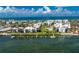 Aerial view of the waterfront condos, a swimming pool, boat docks and lush landscaping in a gated community at 2955 N Beach Rd # D113, Englewood, FL 34223