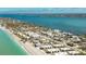 Aerial view of the oceanfront condo community with beach access, parking, mature trees, and views of the ocean at 2955 N Beach Rd # D113, Englewood, FL 34223