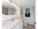 Well-lit bathroom with decorative mirror and starfish wall art at 2955 N Beach Rd # D113, Englewood, FL 34223