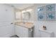 Bathroom with vanity and white wainscoting and coastal theme at 2955 N Beach Rd # D113, Englewood, FL 34223