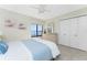 Bright bedroom with water view, white closet doors and wicker dresser at 2955 N Beach Rd # D113, Englewood, FL 34223