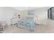 A bright, beach-themed bedroom features tiled floors, coastal decor, and a dresser at 2955 N Beach Rd # D113, Englewood, FL 34223