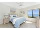 Cozy bedroom features water views, wicker furniture, and a ceiling fan at 2955 N Beach Rd # D113, Englewood, FL 34223