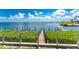 Inviting dock with lush landscaping, perfect for boating, fishing, and enjoying peaceful waterfront views at 2955 N Beach Rd # D113, Englewood, FL 34223