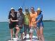 A group of friends on a boat, enjoying a day of fishing on beautiful calm waters at 2955 N Beach Rd # D113, Englewood, FL 34223