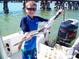 Young Personal on a boat holding up a fish he caught while fishing at sea at 2955 N Beach Rd # D113, Englewood, FL 34223