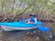 Young boy kayaking through beautiful mangrove tunnels with stunning water views, a fun outdoor activity at 2955 N Beach Rd # D113, Englewood, FL 34223